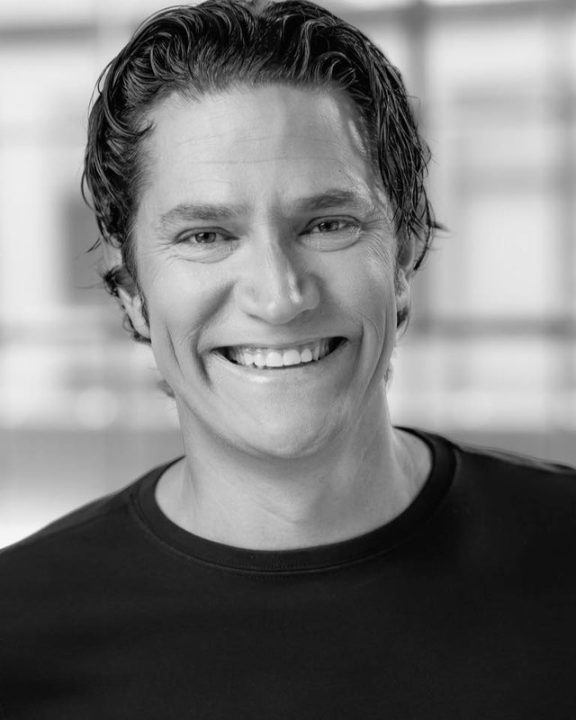 A black-and-white portrait of JD Hudgens.